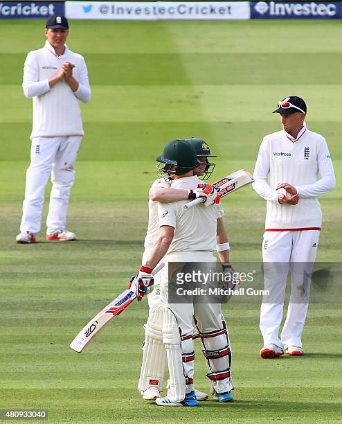 Gary Ballance and Joe Root applaud as Chris Rogers of Australia celebrates scoring a century with Steve Smith during day one of the 2nd Investec...