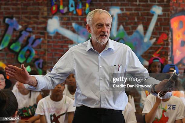 Labour leadership contender Jeremy Corbyn presents pupils with certificates after they perform in a play on their last day of school at Duncombe...