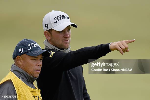 Bernd Wiesberger of Austria talks with his caddie Shane Koerier on the 17th fairway during the first round of the 144th Open Championship at The Old...