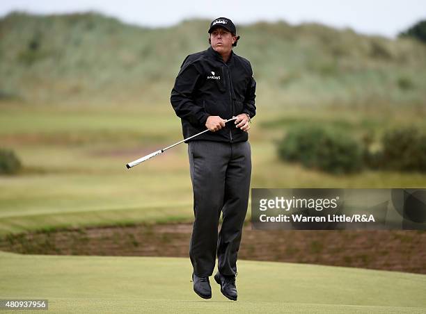 Phil Mickelson of the United States reacts after missing a birdie putt on the 14th green during the first round of the 144th Open Championship at The...