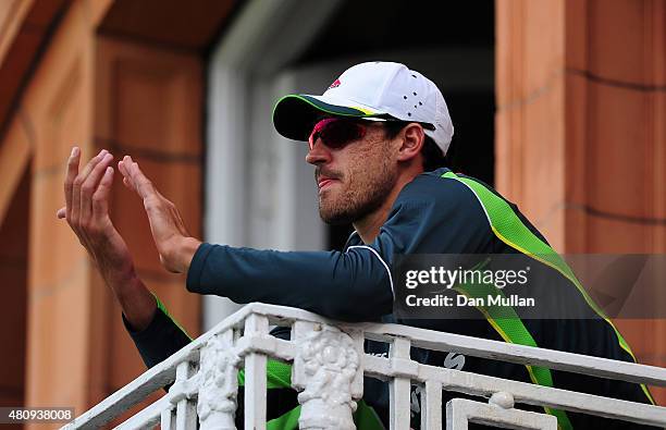 Mitchell Johnson of Australia applauds from the team balcony during day one of the 2nd Investec Ashes Test match between England and Australia at...