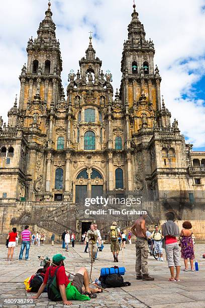 Pilgrims and tourists in Praza da Obradoiro by Baroque style cathedral, Catedral de Santiago de Compostela, Galicia, Spain.