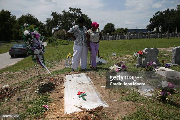 Family members visit the grave of Ethel Lance one of the nine victims of a mass shooting on July 15, 2015 at the Emanuel Methodist Episcopal Church...