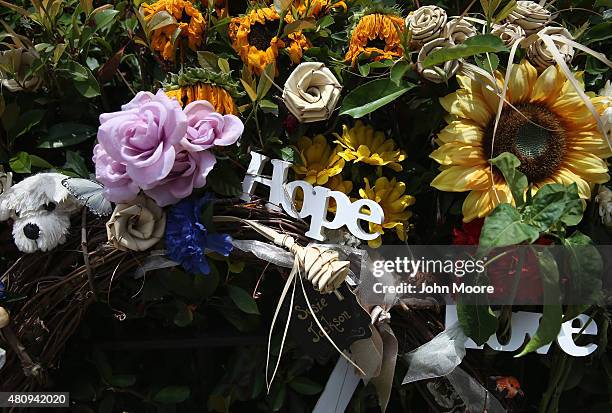 Flowers hang outside the Emanuel African Methodist Episcopal church on July 15, 2015 in downtown Charleston, South Carolina. A makeshift shrine of...