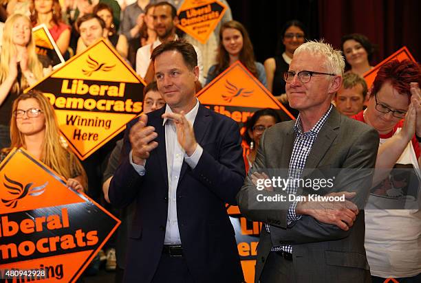 Former Liberal Democrat Party Leader Nick Clegg applauds whilst stood next to Norman Lamb as Tim Farron becomes the new leader of the party at...