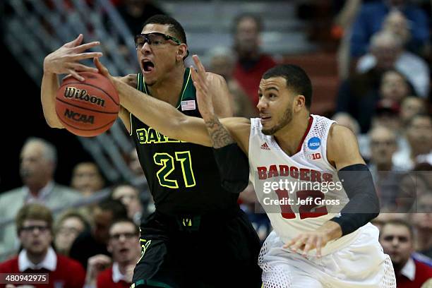 Isaiah Austin of the Baylor Bears and Traevon Jackson of the Wisconsin Badgers go after the ball in the first half during the regional semifinal of...