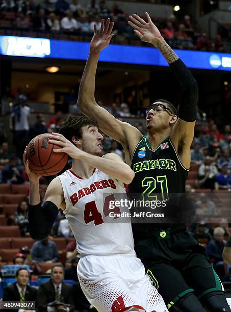 Frank Kaminsky of the Wisconsin Badgers looks to shoot against Isaiah Austin of the Baylor Bears in the first half during the regional semifinal of...