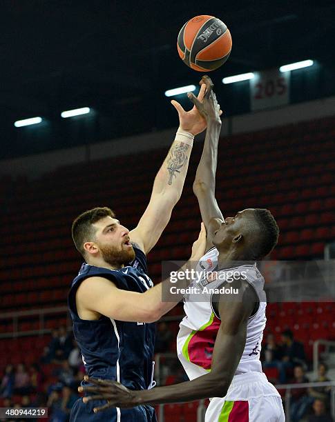 Anadolu Efes' Deniz Kilicli vies with Laboral Kutxa's Ilimane Diop during the Turkish Airlines Euroleague Top 16 Round 12 basketball match between...