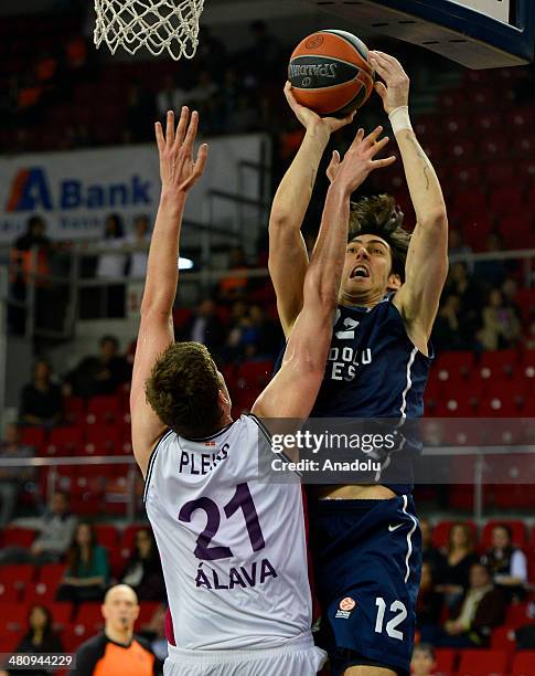 Anadolu Efes' Kerem Gonlum tries to score under the defence of Laboral Kutxa's Tibor Pleiss during the Turkish Airlines Euroleague Top 16 Round 12...