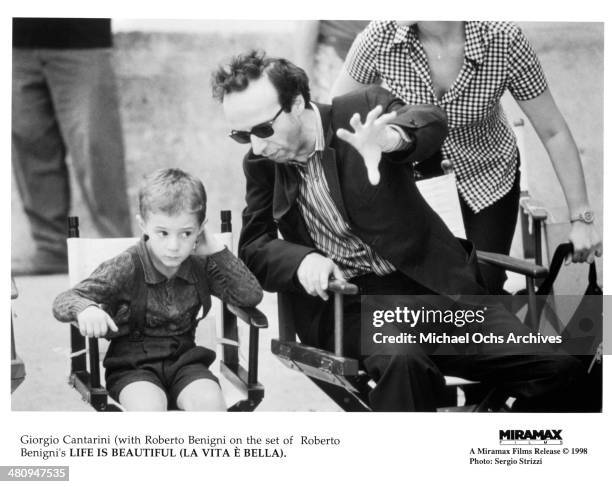 Actors Roberto Benigni and Giorgio Cantarini on the set of the Miramax movie "Life Is Beautiful" circa 1997.