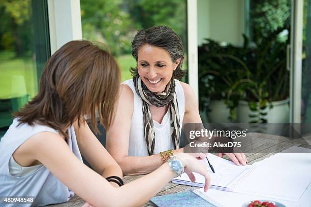 happy mother and daughter having tea outdoor - agenda meeting stock pictures, royalty-free photos & images