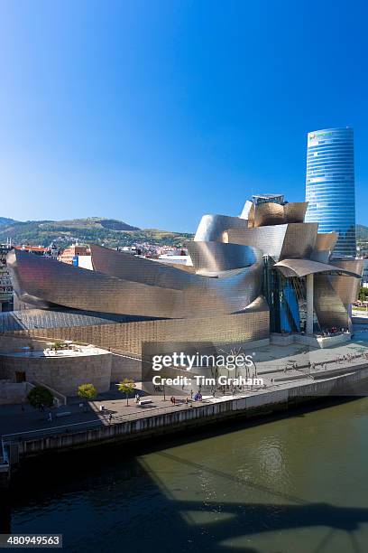 Architect Frank Gehry's Guggenheim Museum futuristic architectural design in titanium and giant spider sculpture in Bilbao, Spain.