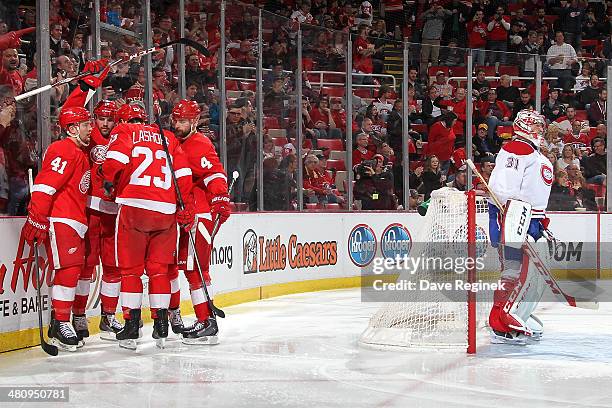 Carey Price of the Montreal Canadiens stands in the crease as Luke Glendening, Brian Lashoff, Jakub Kindl and Tomas Jurco of the Detroit Red Wings...
