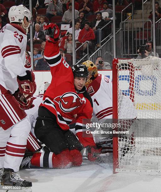 Ryane Clowe of the New Jersey Devils scores at 19:59 of the second period against the Phoenix Coyotes at the Prudential Center on March 27, 2014 in...