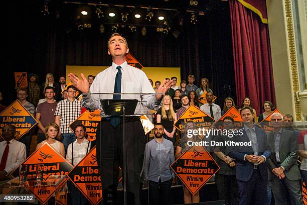 New Liberal Democrat Party Leader Tim Farron gives a speech as he becomes the new leader of the party, watched by former leader Nick Clegg and...