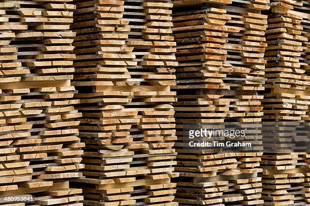 timber planks stacked to season, spain - plank stock pictures, royalty-free photos & images
