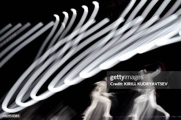 Long long exposure picture shows Japan's Yuki Ota vying with US Alexander Massialas during the men's foil final event at the 2015 World Fencing...
