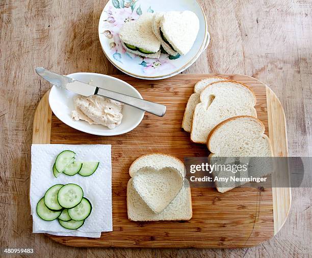 making heart shaped cucumber sandwiches. - pastry cutter stock pictures, royalty-free photos & images