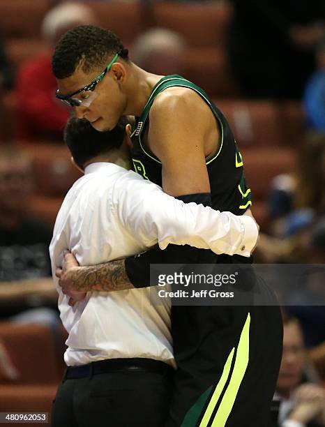 Isaiah Austin hugs his coach head coach Scott Drew of the Baylor Bears as he is taken out of the game in the second half while taking on the...