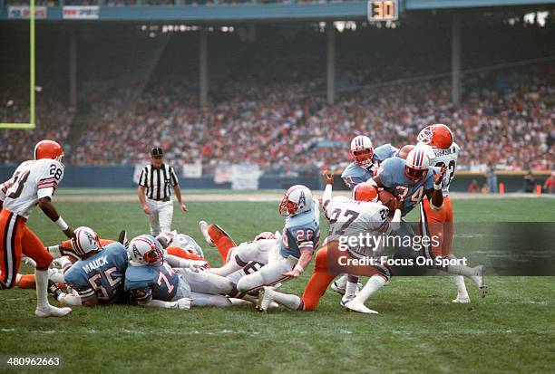 Earl Campbell of the Houston Oilers gets hit by Thom Darden of the Cleveland Browns during an NFL football game December 2, 1979 at Cleveland...