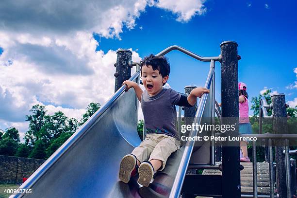 playing - children's slide stock pictures, royalty-free photos & images