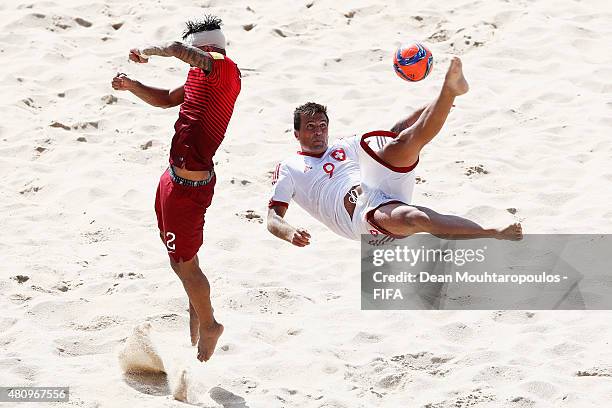 Dejan Stankovic of Switzerland attempts a scissor kick shot on goal in front of Coimbra of Portugal during the FIFA Beach Soccer World Cup quarter...