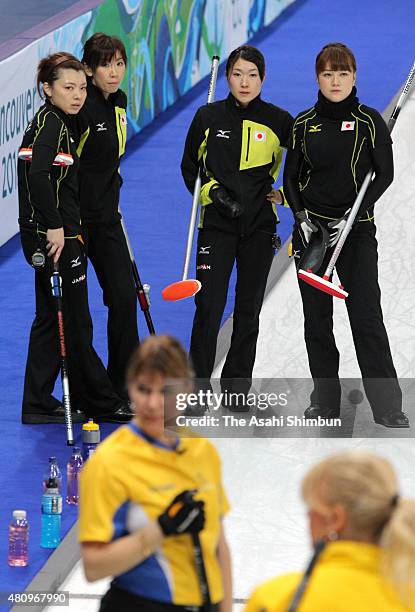 Mari Motohashi, Kotomi Ishizaki, Moe Meguro and Mayo Yamaura of Japan look on during the Curling Women's round robin game against Sweden during day...