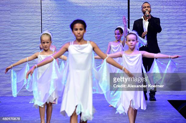Children perform during a song of Joseph Guyton of Nica & Joe on the runway during the Ernsting's family Fashion Show Autumn/Winter 2015 at Hotel...