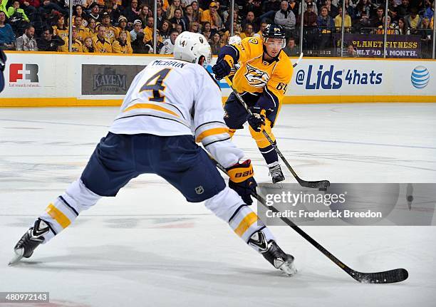Victor Bartley of the Nashville Predators shoots the puck against Jamie McBain of the Buffalo Sabres at Bridgestone Arena on March 27, 2014 in...