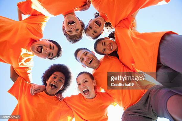 coach with group of children - huddle sport girls stock pictures, royalty-free photos & images