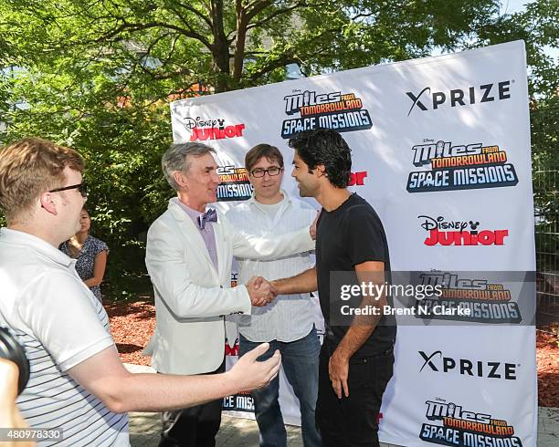 Scientist/educator Bill Nye greets actor Adrian Grenier as creator/executive producer of "Miles from Tomorrowland" Sascha Paladino looks on during...