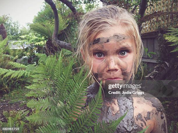 child covered in mud standing outside in garden - people covered in mud stock pictures, royalty-free photos & images