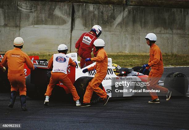 Alain Prost from France driving the Marlboro McLaren-Honda MP4/5 controversially collides with his team mate Ayrton Senna during the Japanese Grand...