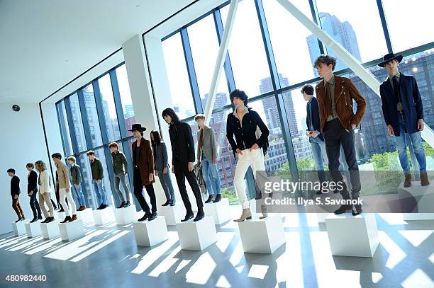 Models pose at the J. Lindeberg presentation during New York Fashion Week: Men's S/S 2016 at Spring Studios on July 16, 2015 in New York City.