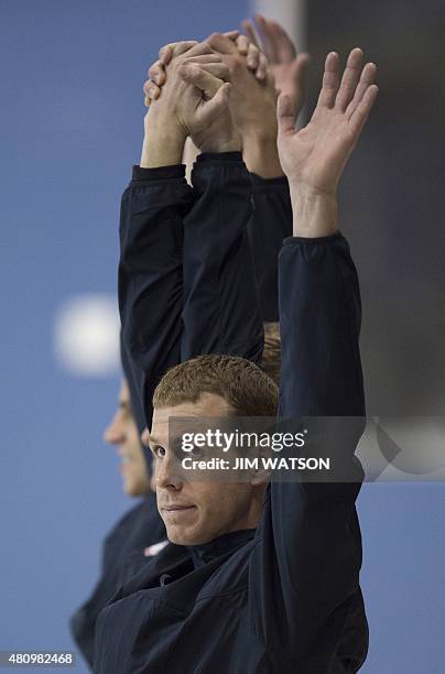 Darian Townsend of USA waves to the crowd with his teammates after they were awarded the silver medal in the Men's 4X200M Freestyle Relay finals at...