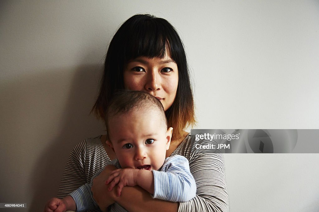 Portrait of mother holding baby boy