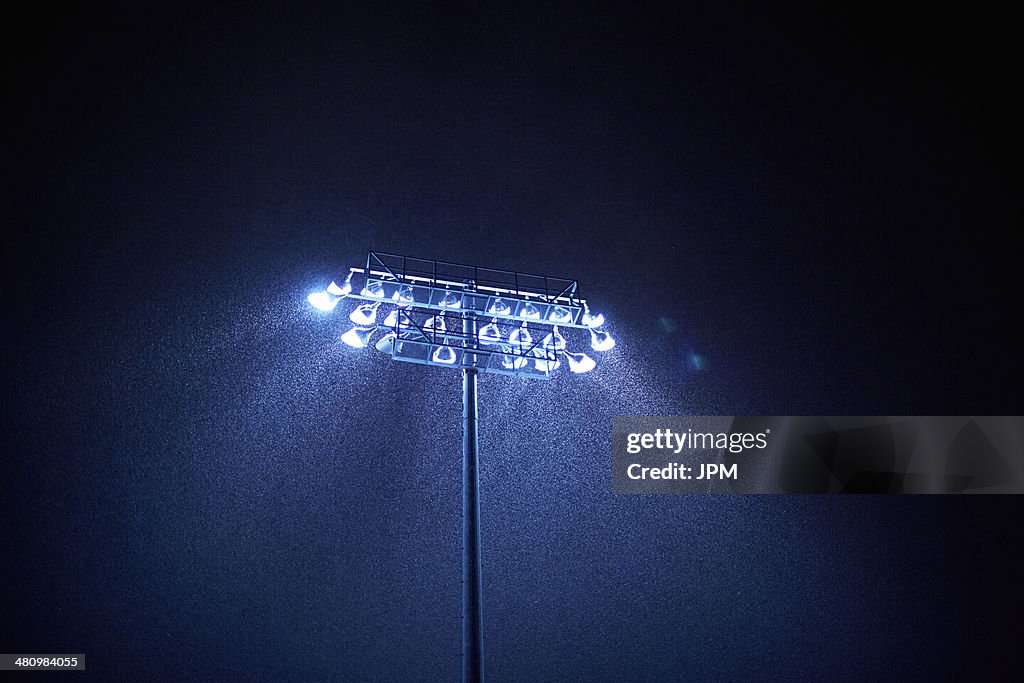 Dark sky and floodlight in rain