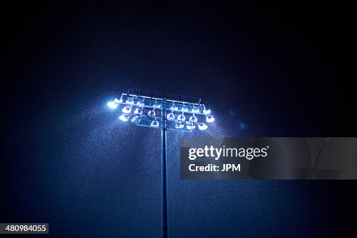 Dark sky and floodlight in rain Dark sky and floodlight in rain