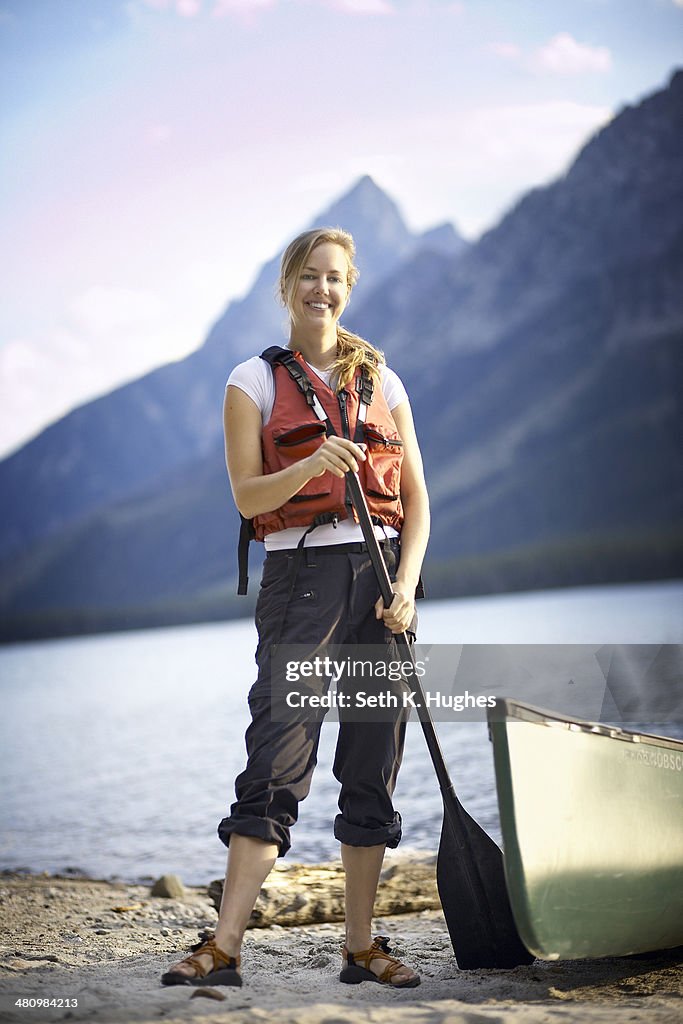 Portrait of female canoeist by lake, Grand Tetons, Wyoming, USA