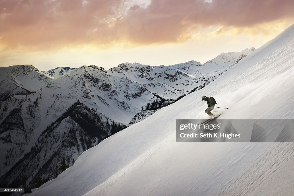 Mid adult man skiing down mountain, Golden, British Columbia, Canada