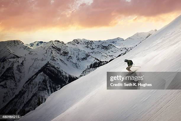 mid adult man skiing down mountain, golden, british columbia, canada - mountain side stock pictures, royalty-free photos & images