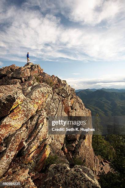 man standing on rock formation, boulder, colorado, usa - boulder rock stock-fotos und bilder