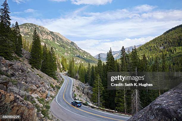 car on winding highway, aspen, colorado, usa - blue car stock pictures, royalty-free photos & images