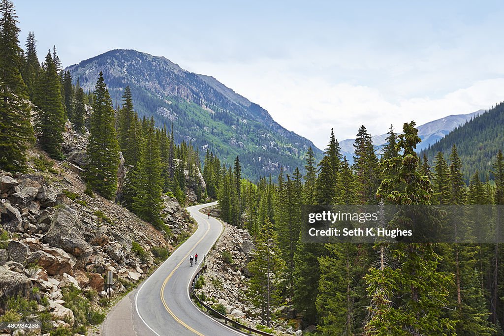 Cyclists on winding highway, Aspen, Colorado, USA