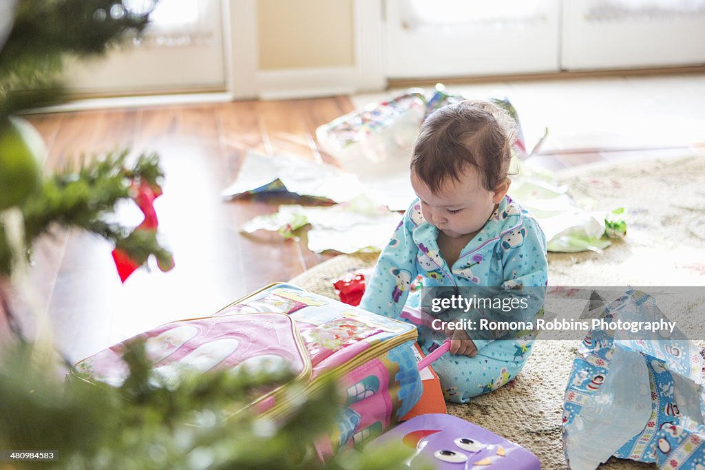 Baby girl opening christmas presents