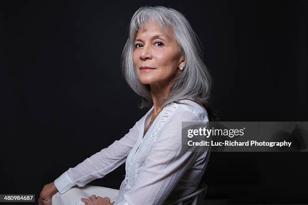 studio portrait of aloof senior woman - grey hair cool woman stock-fotos und bilder