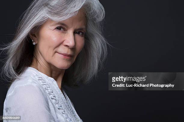 studio portrait of beautiful senior woman - grey blouse stock pictures, royalty-free photos & images