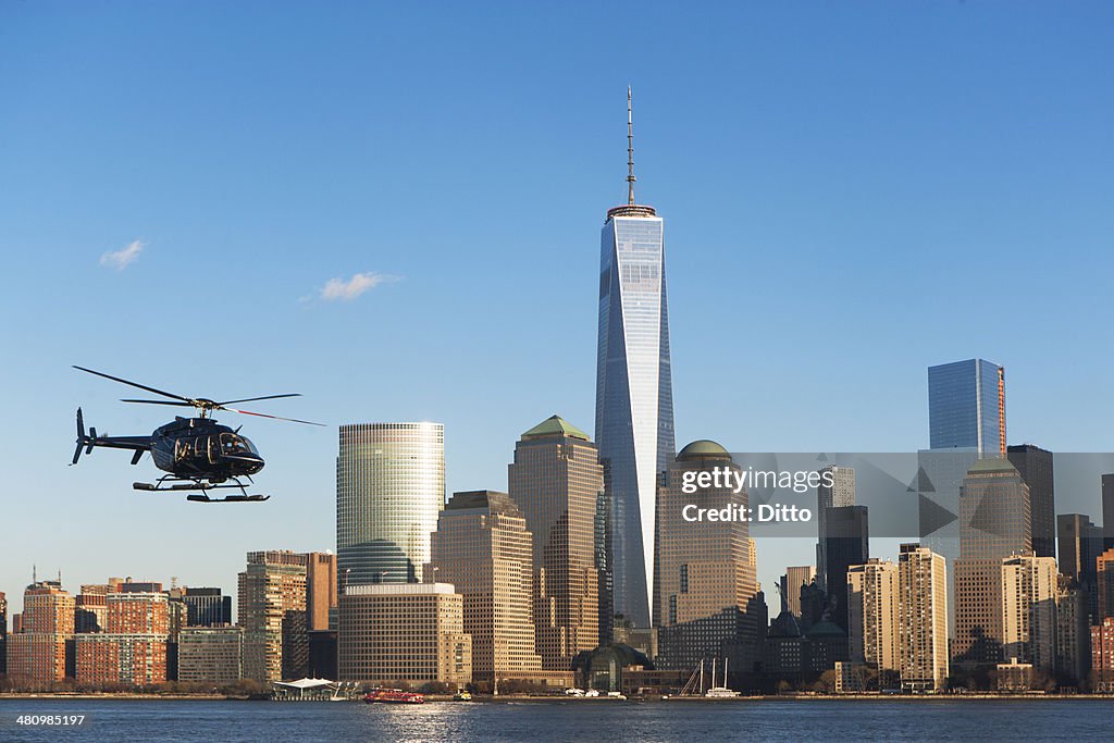 Helicopter flying over river, New York, USA