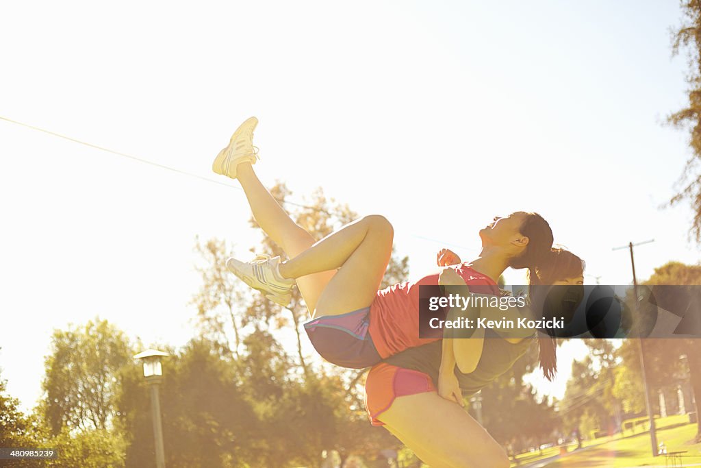 Two young women having fun in park