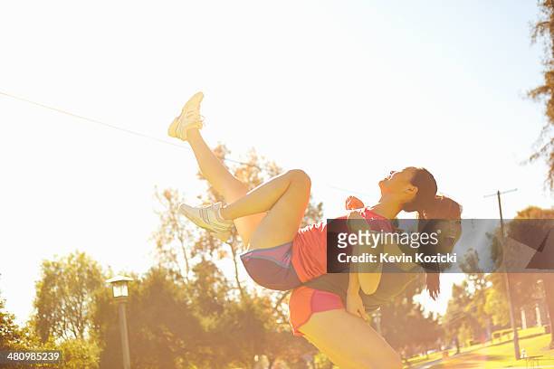 two young women having fun in park - south pasadena california stock pictures, royalty-free photos & images